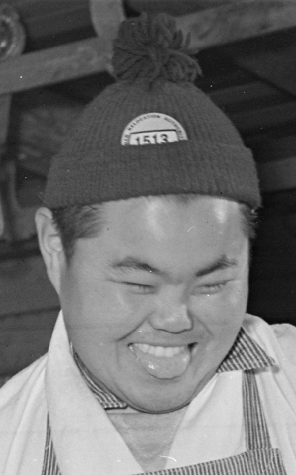 Face detail, Rohwer Relocation Center, McGehee, Arkansas. Sam Takeda, a former west coast butcher, cutting a be . . . - NARA - 539370 (cropped)