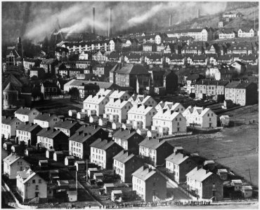 France. UNDER A SMOKE-SMEARED SUNDAY SKY, steel workers's dwellings in Nilvange, France, look strangely white... - NARA - 541673 photo