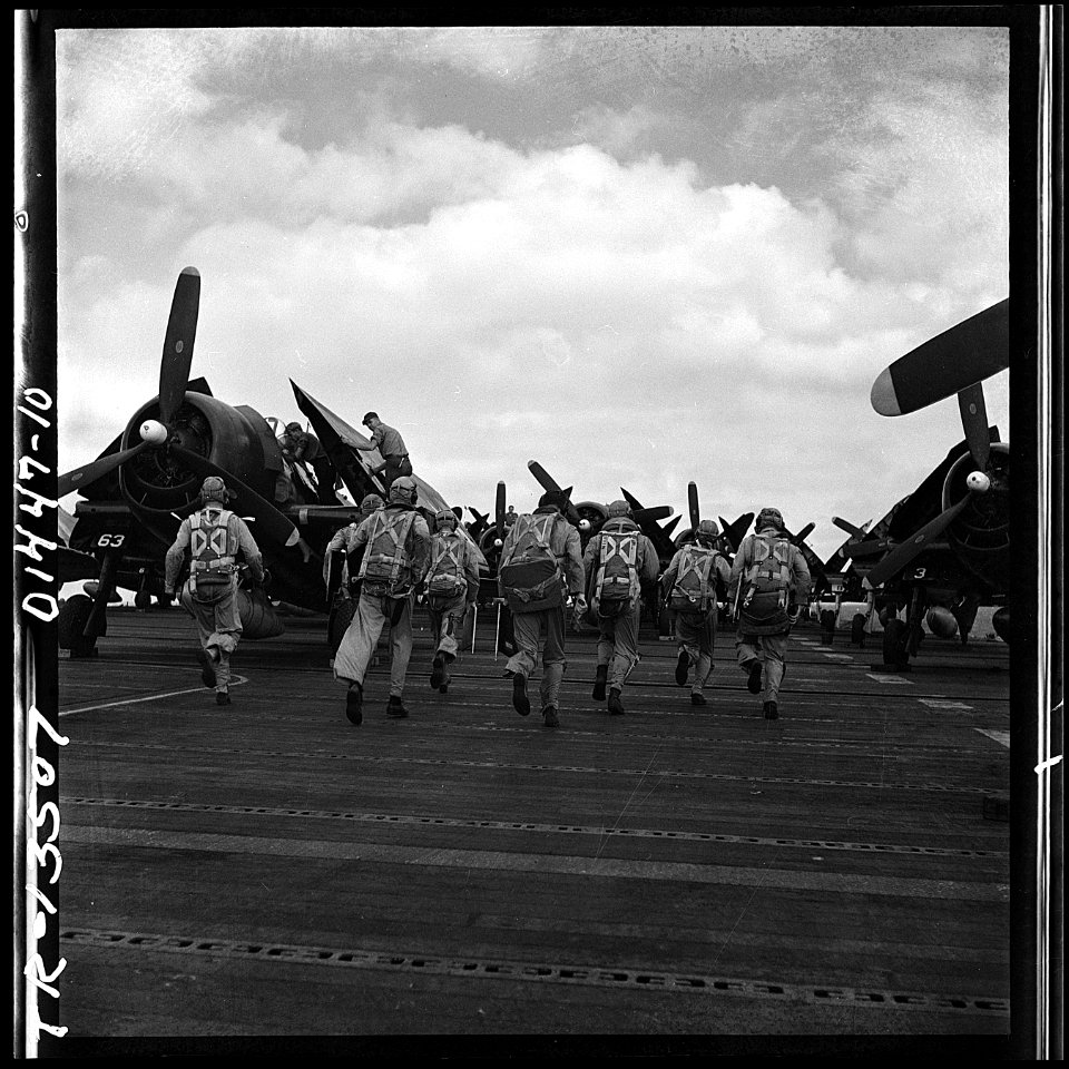 F6F pilots rushing to their planes on the flight deck of the USS Hornet (CV-12). They are going out for a raid on... - NARA - 520866