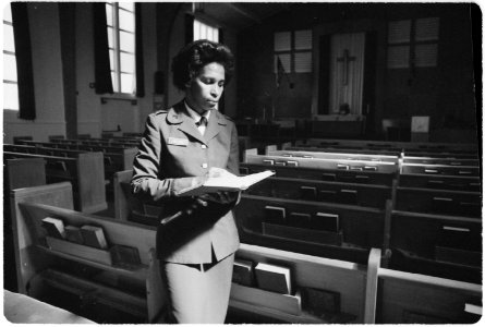 Fort Stewart, Georgia. Female chaplain. Captian Stella Sellers, an Army Chaplain at Hunter Post Chapel, reads... - NARA - 531471 photo