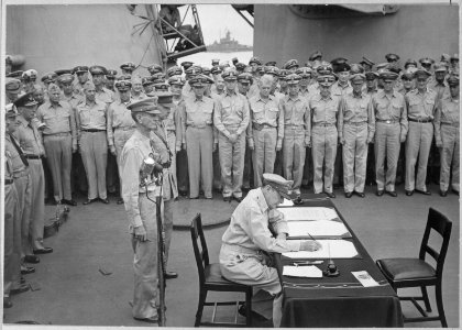 General Douglas MacArthur signs as Supreme Allied Commander during formal surrender ceremonies on the USS MISSOURI in... - NARA - 520694