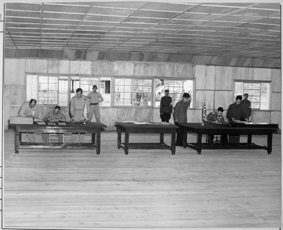 General W. K. Harrison, Jr., signs armistice ending 3-year Korean conflict. Genearl Harrison, left table, and North... - NARA - 520995