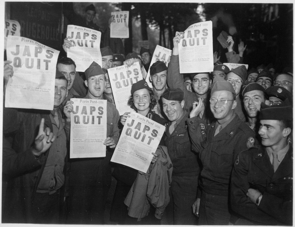 GI's at the Rainbow Corner Red Cross Club in Paris, France, whoop it up after buying the special edition of the Paris... - NARA - 531309