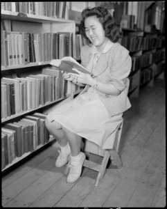 Gila River Relocation Center, Rivers, Arizona. Mary Nakagaki studying in the library at this center. - NARA - 538645