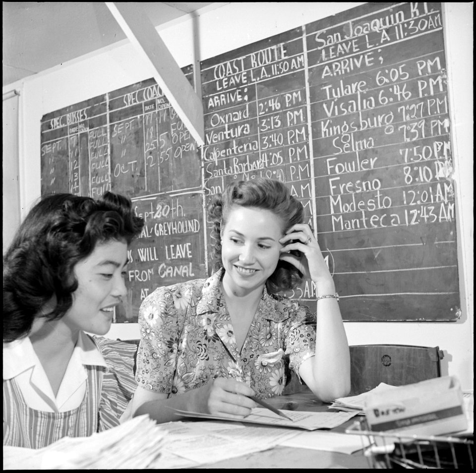 Gila River Relocation Center, Rivers, Arizona. Midge Kajikawa receiving travel instruction from lea . . . - NARA - 539834
