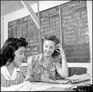 Gila River Relocation Center, Rivers, Arizona. Midge Kajikawa receiving travel instruction from lea . . . - NARA - 539834