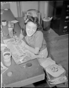 Gila River Relocation Center, Rivers, Arizona. Painting a sign for the Harvest Festival to be hel . . . - NARA - 538637