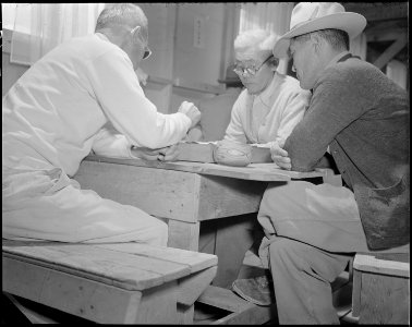 Gila River Relocation Center, Rivers, Arizona. Three evacuees playing the age old Japanese game of . . . - NARA - 538638