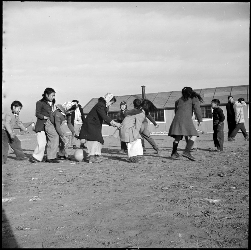 Granada Relocation Center, Amache, Colorado. Over and under, with a volley ball is an exciting ga . . . - NARA - 539070