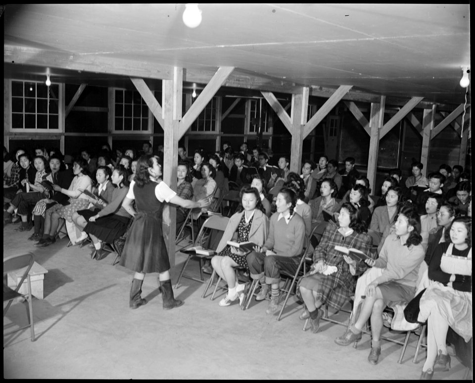Granada Relocation Center, Amache, Colorado. A choral group of 200 volunteer voices practicing for . . . - NARA - 539028