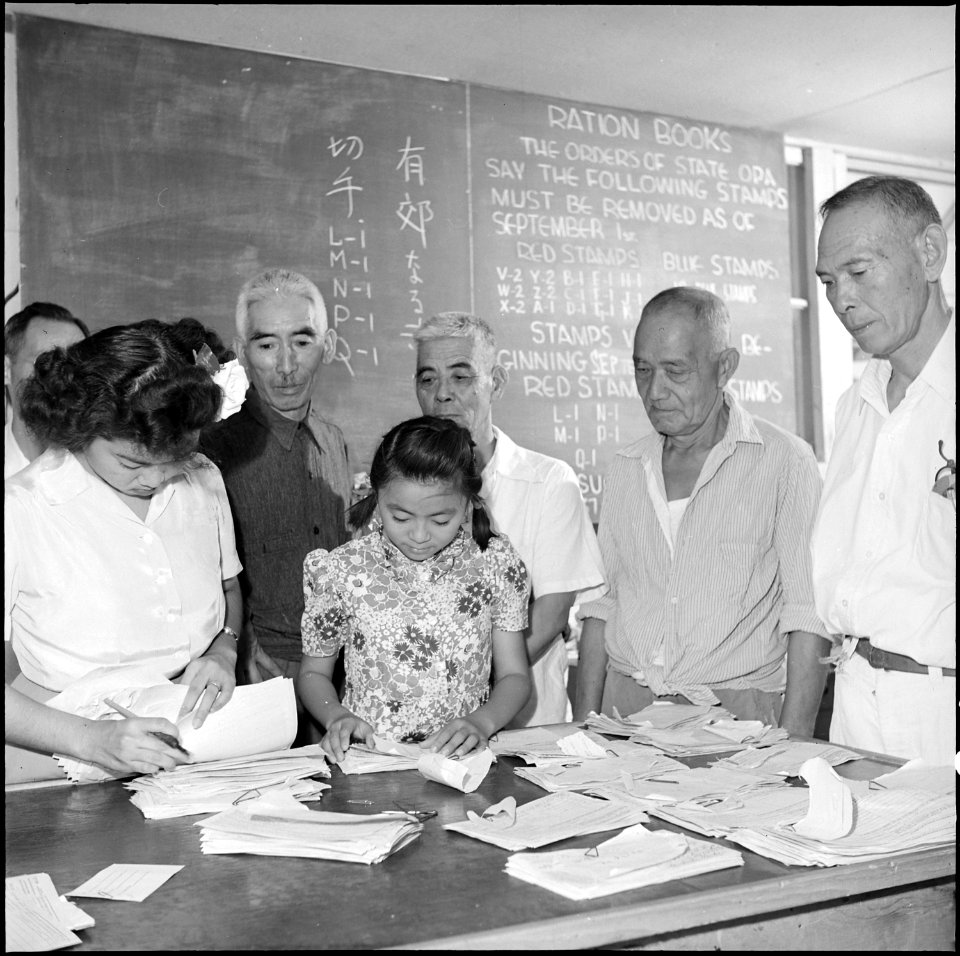 Gila River Relocation Center, Rivers, Arizona. Ration book being issued to the resettlers. On Sept . . . - NARA - 539824