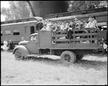 Granada Relocation Center, Amache, Colorado. A truck load of young evacuees leaving the Granada rai . . . - NARA - 538736