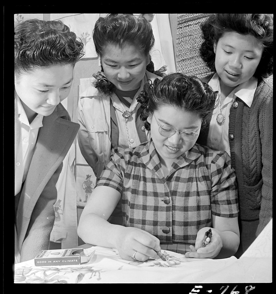 Granada Relocation Center, Amache, Colorado. A closeup of textile work. Yasko Taniguchi (seated) i . . . - NARA - 539299