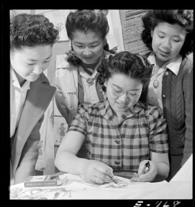Granada Relocation Center, Amache, Colorado. A closeup of textile work. Yasko Taniguchi (seated) i . . . - NARA - 539299