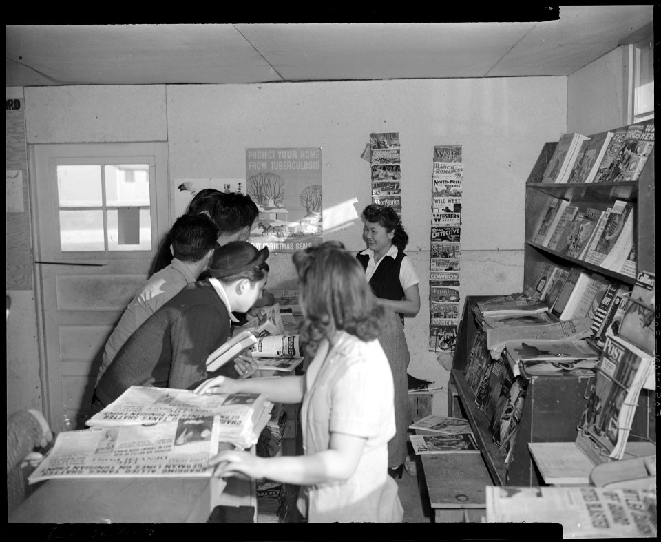 Granada Relocation Center, Amache, Colorado. A magazine and newsstand in the cooperative canteen. - NARA - 539017
