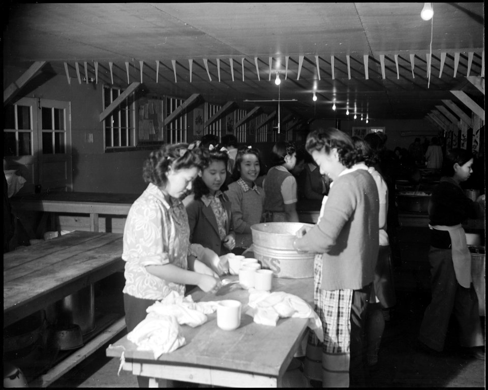 Granada Relocation Center, Amache, Colorado. A kitchen crew wiping the last remnants of the evening . . . - NARA - 539055