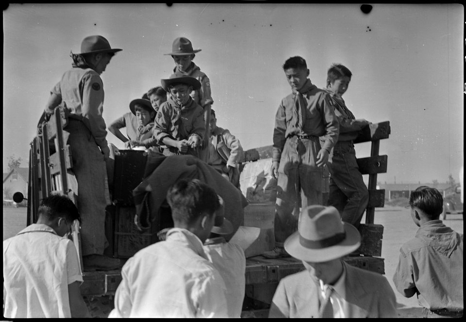 Granada Relocation Center, Amache, Colorado. Amache Boy Scouts help with the check baggage. - NARA - 537366