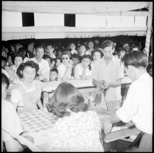 Granada Relocation Center, Amache, Colorado. A silk screen booth produced clever souvenirs, string . . . - NARA - 539406