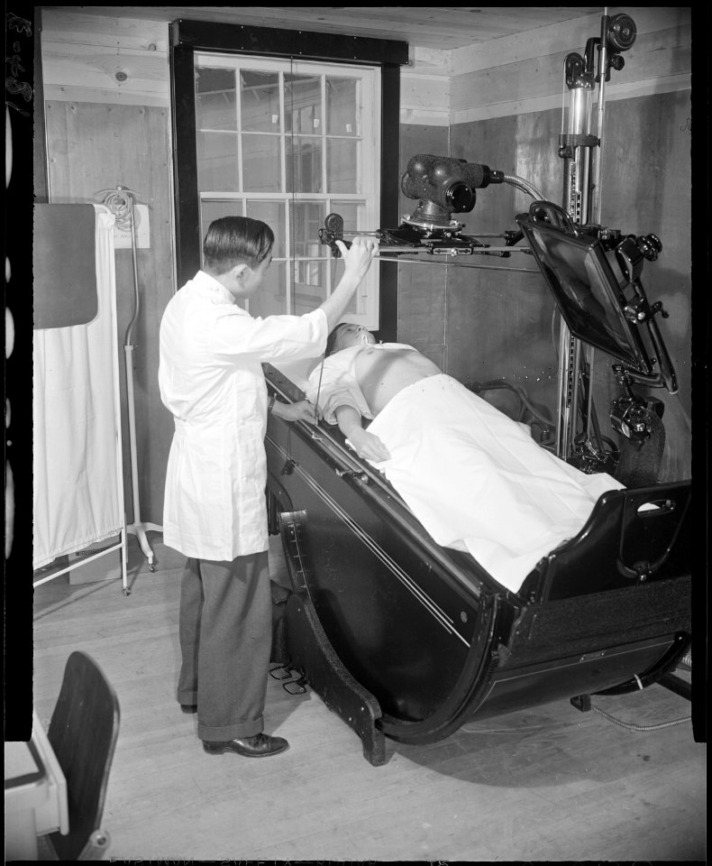Granada Relocation Center, Amache, Colorado. An X-ray technician prepares to take an abdominal X-ra . . . - NARA - 539048