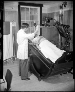 Granada Relocation Center, Amache, Colorado. An X-ray technician prepares to take an abdominal X-ra . . . - NARA - 539048