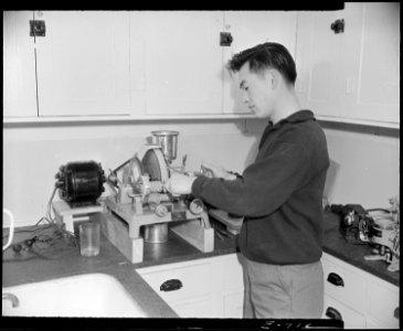 Granada Relocation Center, Amache, Colorado. A young worker of Japanese ancestry grinding eye glass . . . - NARA - 538997