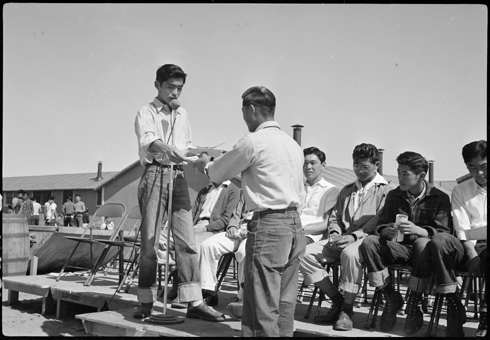 Granada Relocation Center, Amache, Colorado. Akira Sameshima, student body president, presenting at . . . - NARA - 537167