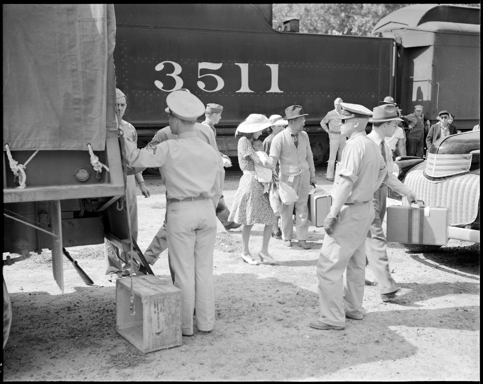 Granada Relocation Center, Amache, Colorado. A young mother and baby receives special attention as . . . - NARA - 538743