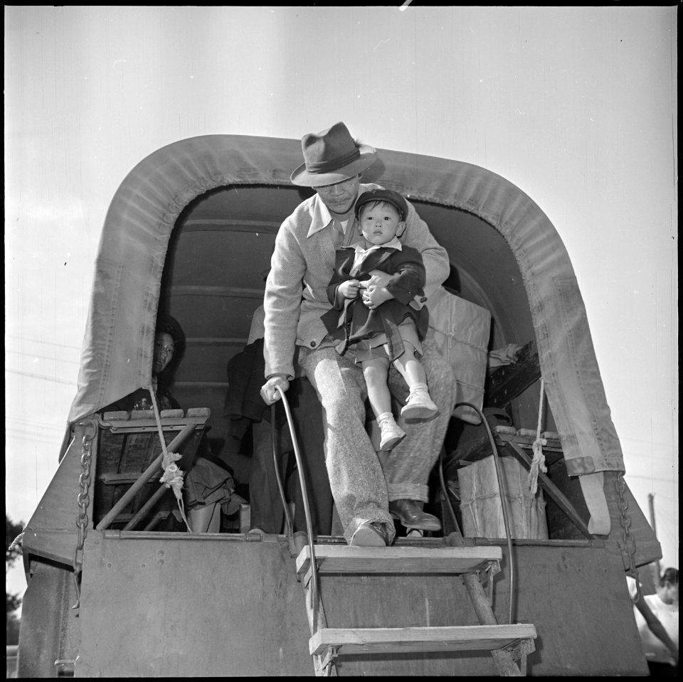 Granada Relocation Center, Amache, Colorado. Center residents arrive by truck from Amache to board . . . - NARA - 539944
