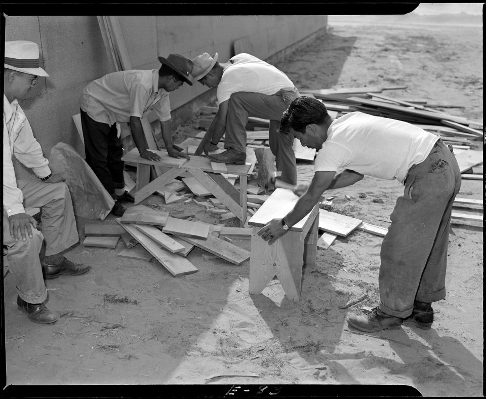Granada Relocation Center, Amache, Colorado. Early arrivals preparing benches and makeshift seats t . . . - NARA - 538746