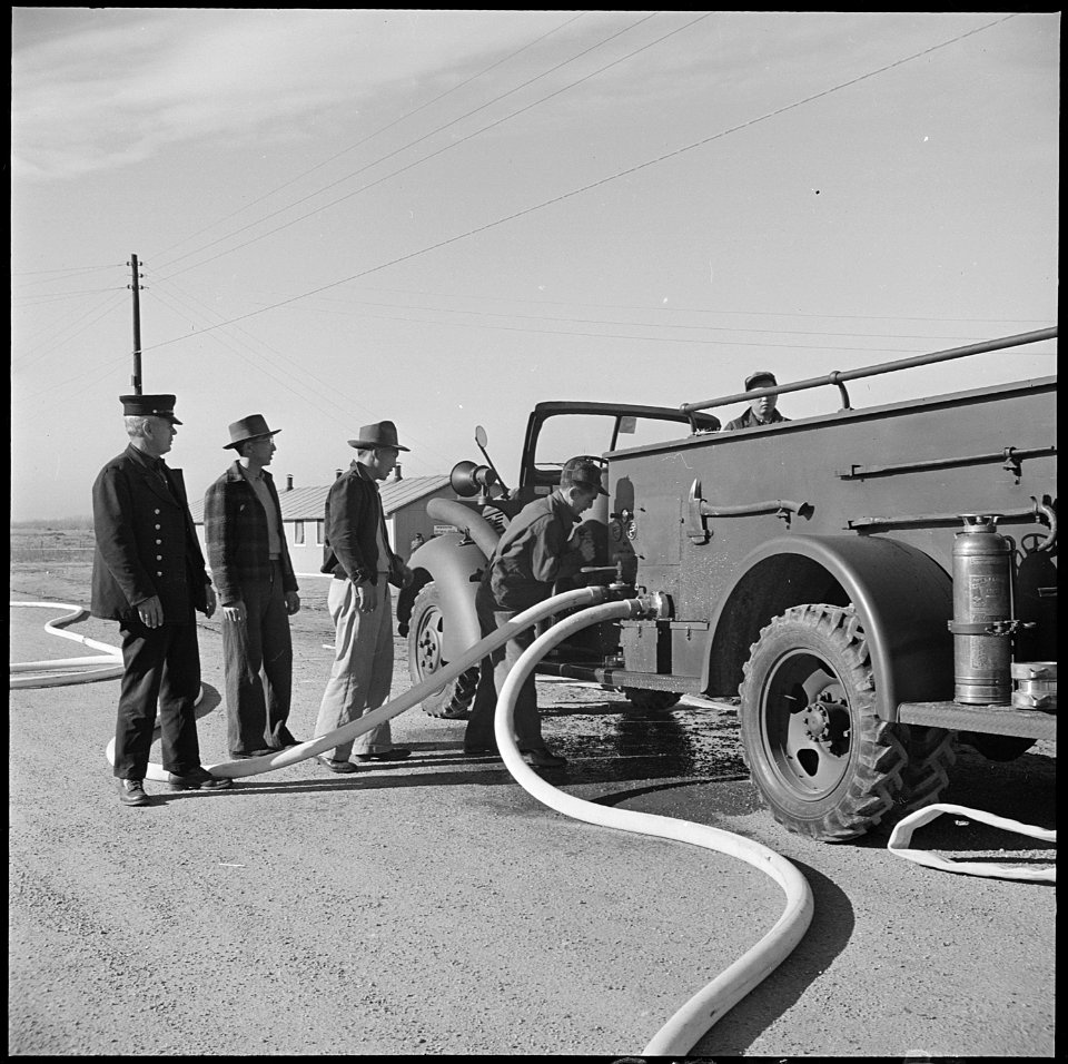 Granada Relocation Center, Amache, Colorado. Fire drill, and under the direction of a Caucasian Fir . . . - NARA - 539133