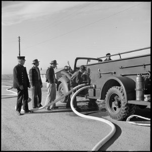 Granada Relocation Center, Amache, Colorado. Fire drill, and under the direction of a Caucasian Fir . . . - NARA - 539133