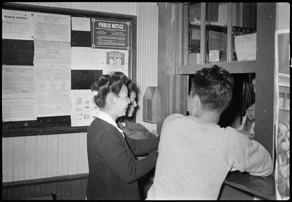 Granada Relocation Center, Amache, Colorado. Evacuees going out on leave getting train information . . . - NARA - 537315