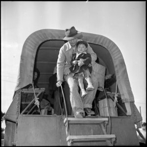 Granada Relocation Center, Amache, Colorado. Center residents arrive by truck from Amache to board . . . - NARA - 539944 photo