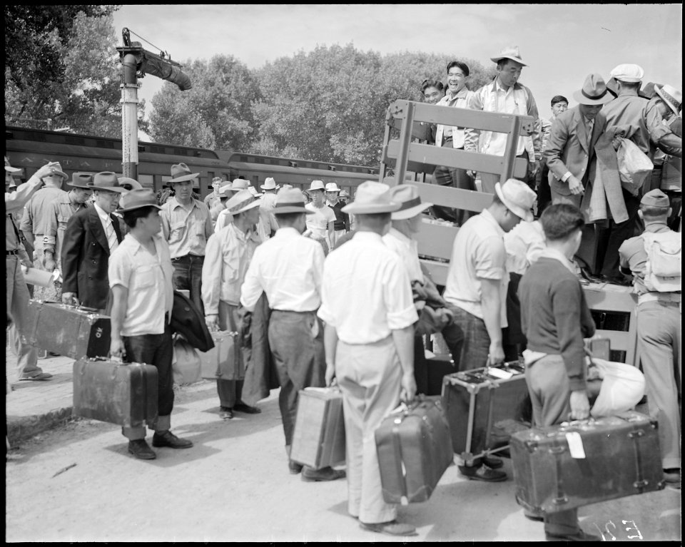 Granada Relocation Center, Amache, Colorado. First evacuees at the center assemble and board trucks . . . - NARA - 538735