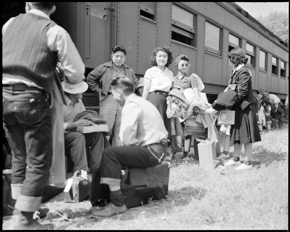 Granada Relocation Center, Amache, Colorado. First evacuee arrivals at Granada assemble alongside . . . - NARA - 538734
