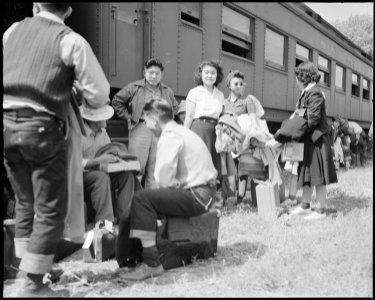 Granada Relocation Center, Amache, Colorado. First evacuee arrivals at Granada assemble alongside . . . - NARA - 538734