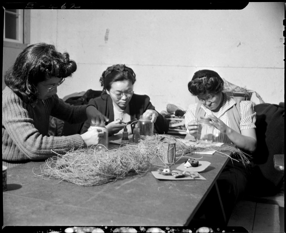Granada Relocation Center, Amache, Colorado. In an adult crafts class, these students unravel used . . . - NARA - 539032