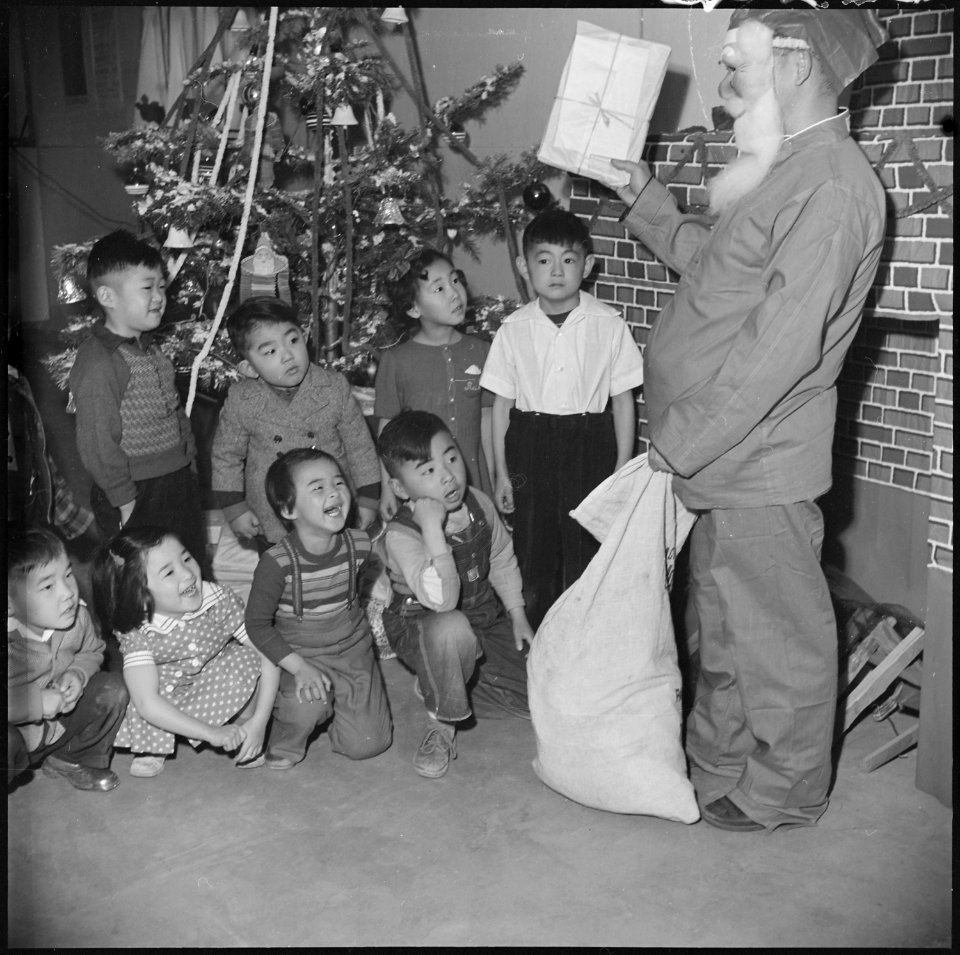 Granada Relocation Center, Amache, Colorado. In his Santa Claus mask, wearing a pair of red pajamas . . . - NARA - 539497