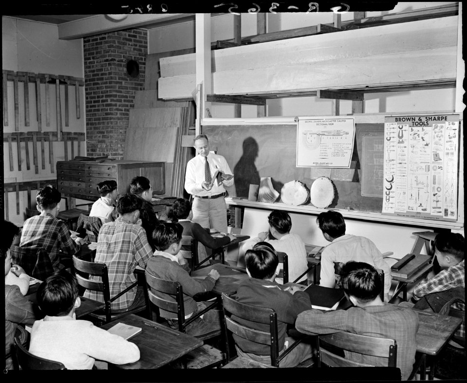 Granada Relocation Center, Amache, Colorado. Leo W. Kraus instructing high school class in properti . . . - NARA - 539604
