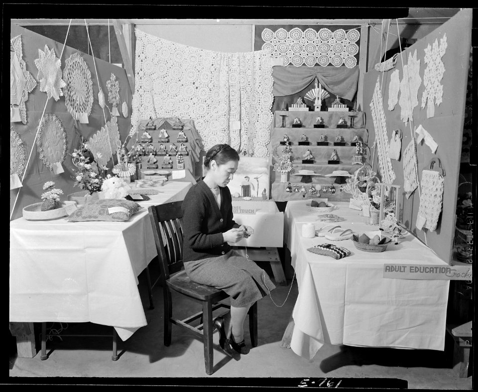Granada Relocation Center, Amache, Colorado. Mrs. Tom Kusumi in charge of the needle work exhibit a . . . - NARA - 539292