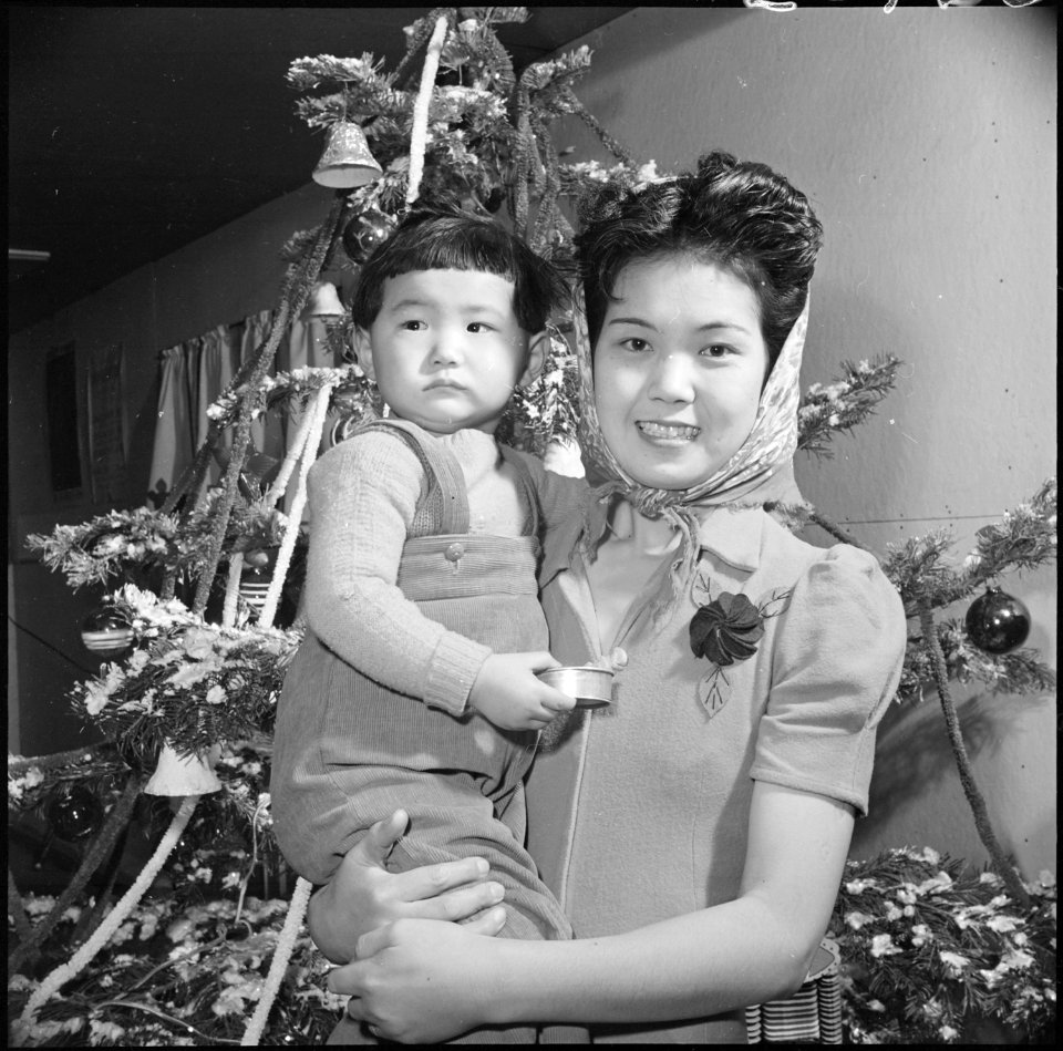 Granada Relocation Center, Amache, Colorado. Mrs. Tomiye Funai brings her two year old daughter Car . . . - NARA - 539410