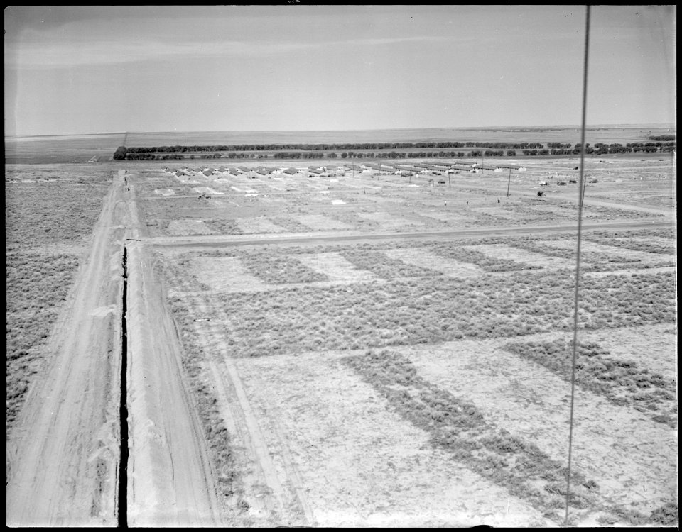 Granada Relocation Center, Amache, Colorado. Looking west over a section of the relocation center j . . . - NARA - 538751