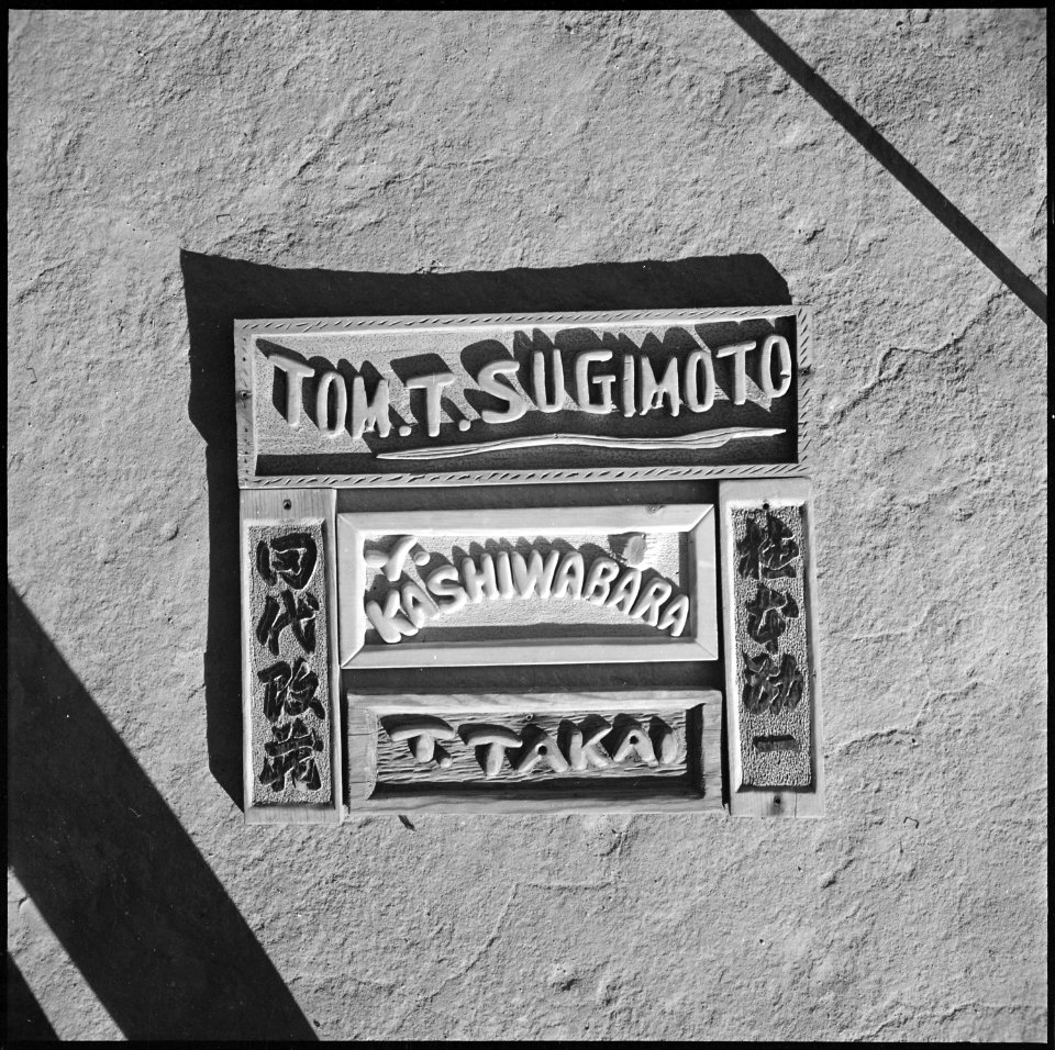 Granada Relocation Center, Amache, Colorado. Name plate in English letters and Japanese characters . . . - NARA - 539921