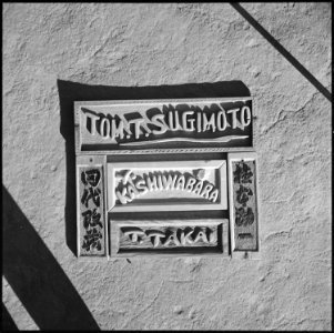 Granada Relocation Center, Amache, Colorado. Name plate in English letters and Japanese characters . . . - NARA - 539921
