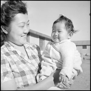 Granada Relocation Center, Amache, Colorado. Mrs. Kobayashi and the youngest of her family. - NARA - 539089