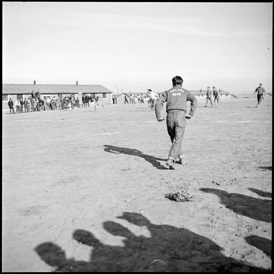 Granada Relocation Center, Amache, Colorado. The center has many small group football groups and ha . . . - NARA - 539074
