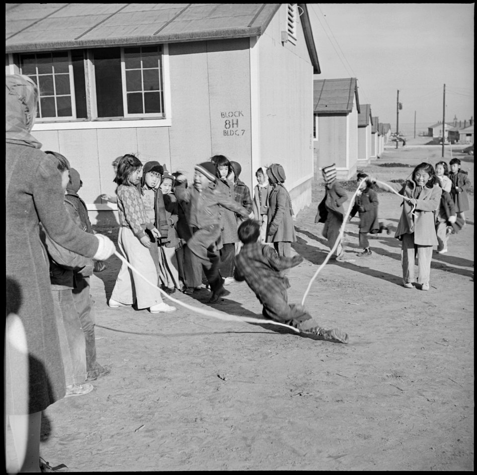 Granada Relocation Center, Amache, Colorado. Primary school children jumping rope during a recess p . . . - NARA - 539113