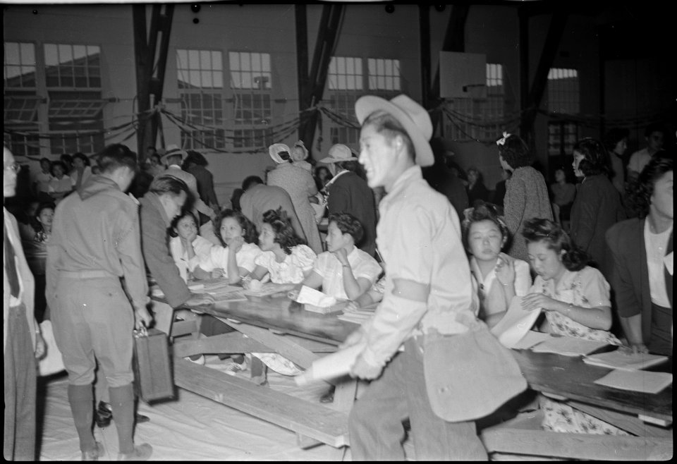 Granada Relocation Center, Amache, Colorado. Registration table for the new residents from Tule. - NARA - 537312