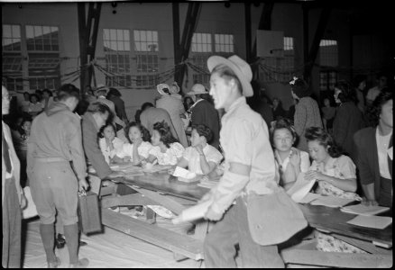 Granada Relocation Center, Amache, Colorado. Registration table for the new residents from Tule. - NARA - 537312