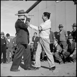 Granada Relocation Center, Amache, Colorado. The loop on a police club and its long handle are used . . . - NARA - 539096